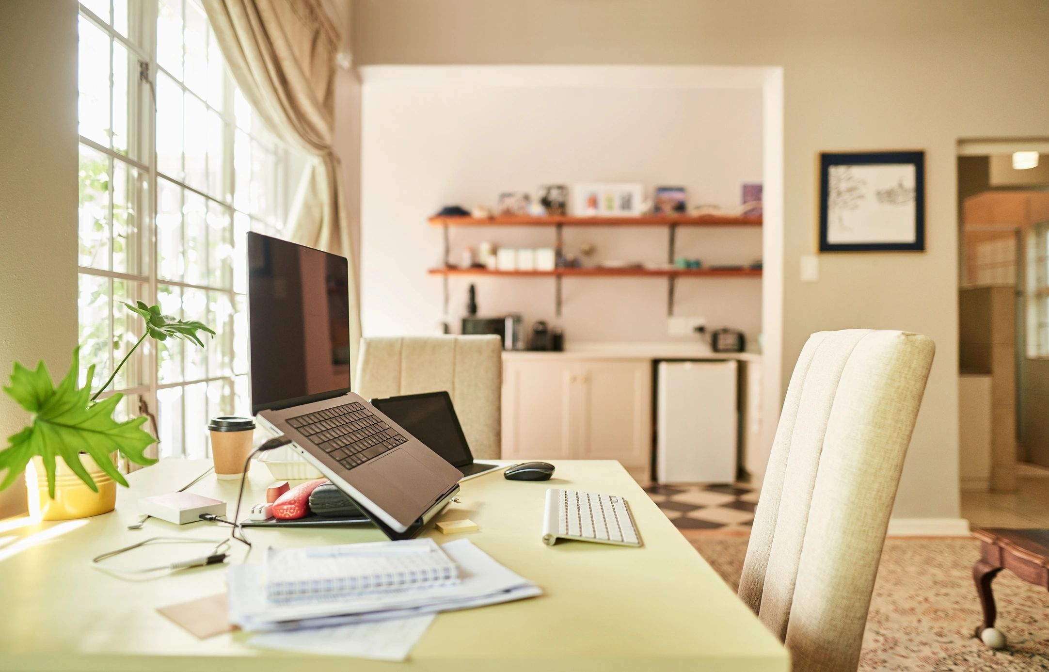 Bright desk scene with notebook, tablet, and creative workspace details