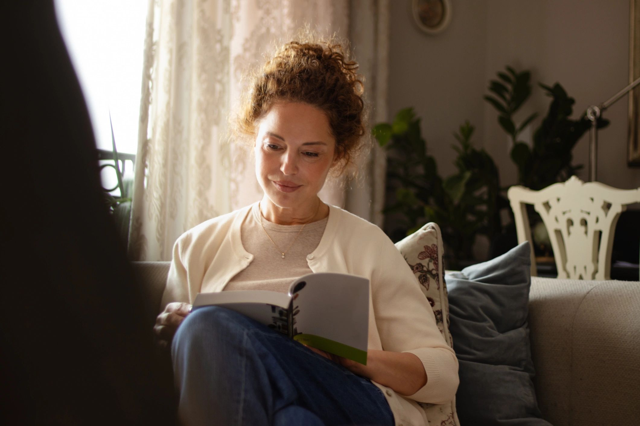 Reader with a book at home